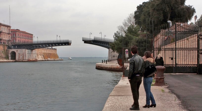 Turistas observando a Ponte Girevole se abrir 